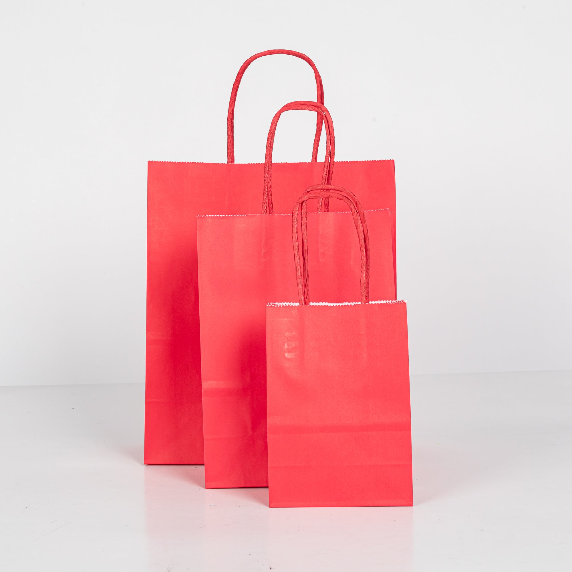 12x Papieren tas gedraaid handvat - 16cm x 22cm x 8cm - Roze