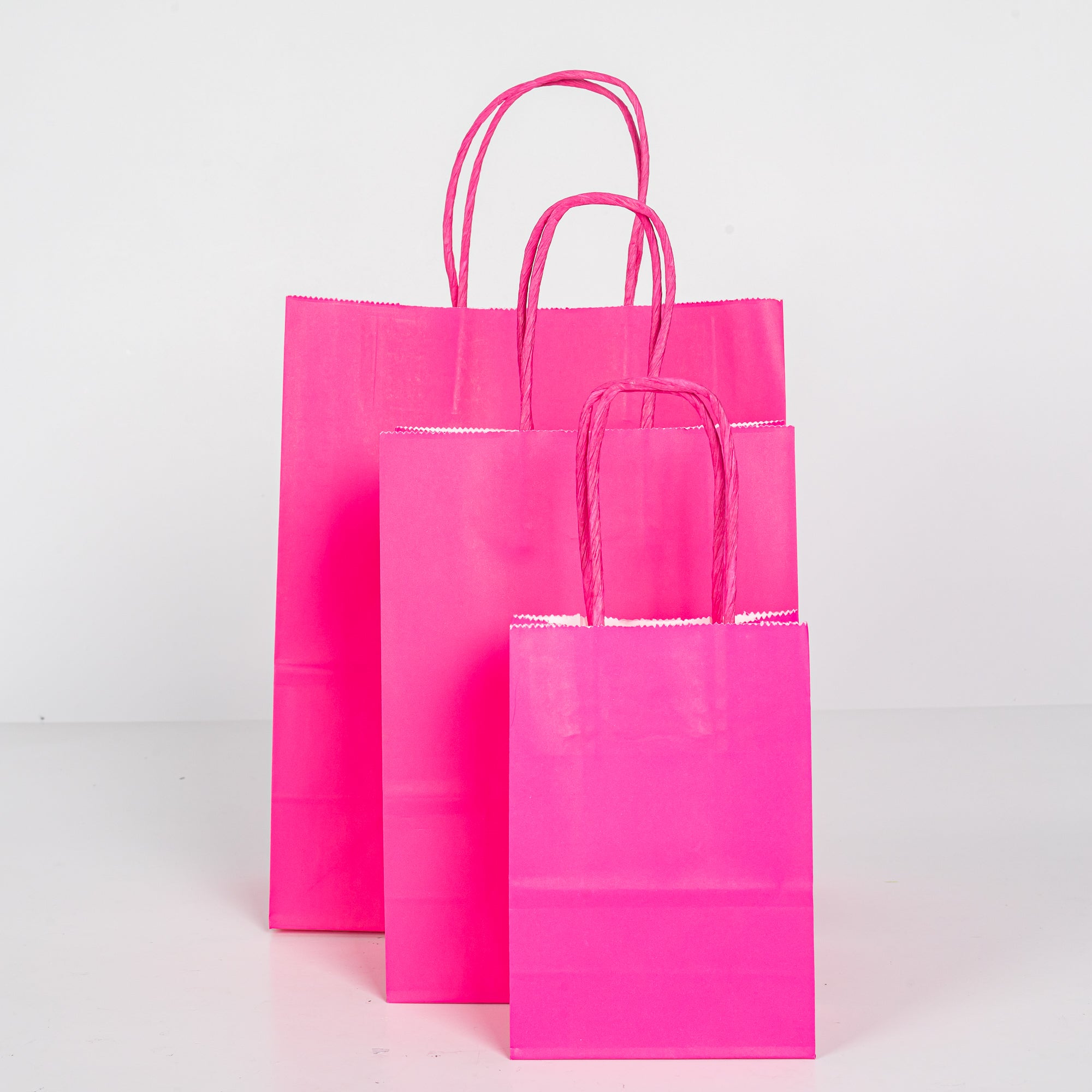 12x Papieren tas gedraaid handvat - 11cm x 15cm x 6cm - Hot Pink